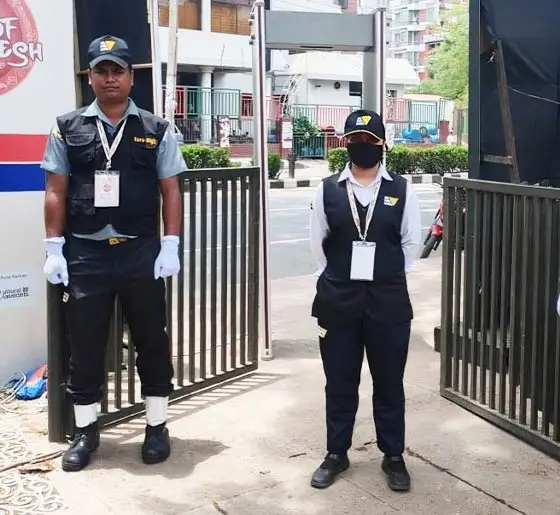 Manned security personnel stationed at a commercial facility entrance gate