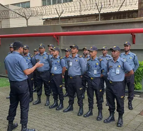 Supervisor conducting an operational briefing for a manned security services team